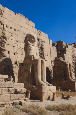Ancient Sandstone Ruins of Old  Egyptian God in the Karnak Temple Complex near Luxor, Egypt clipart