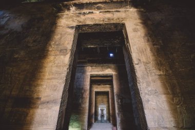 Edfu Tapınağı 'nın iç manzarası. Duvarda oyulmuş sütunlar ve Eski Mısır çizimleri var. 