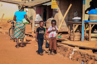 Kumasi, Ghana - April 04, 2022: African playing Children on the Village Street