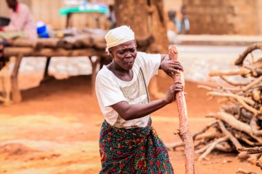 Kumasi, Ghana - April 04, 2022: African Woman working in local village of Ghana