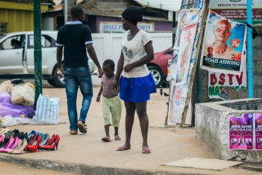 Accra, Ghana - April 06, 2022: Local African Ghana People walking to the daily activities on the Accra Streets