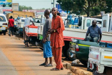 Accra, Ghana - April 06, 2022: Local African Ghana People walking to the daily activities on the Accra Streets