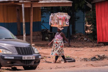 Accra, Ghana - April 06, 2022: Local African Street Woman Seller on the  Accra street