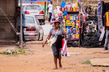 Accra, Ghana - April 06, 2022: Local African Street Woman Seller on the  Accra street
