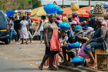 Accra, Ghana - April 06, 2022: Local African Street Woman Seller on the  Accra street