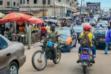 Kumasi, Ghana - April 06, 2022: Crowded African Road with Local Ghana People in Kumasi city