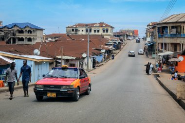 Kumasi, Ghana - April 06, 2022: Crowded African Road with Local Ghana People in Kumasi city