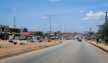Kumasi, Ghana - April 06, 2022: Crowded African Road with Local Ghana People in Kumasi city