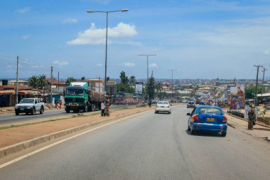 Kumasi, Ghana - April 06, 2022: Crowded African Road with Local Ghana People in Kumasi city