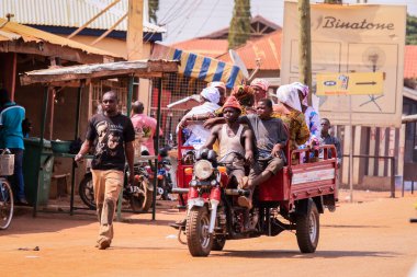 Tamale, Ghana - April 07, 2022: African Road with Local Ghana People on Vehicle in Tamale city