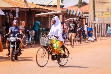 Tamale, Ghana - April 07, 2022: African Road with Local Ghana People on Vehicle in Tamale city