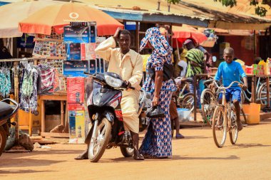 Tamale, Ghana - April 07, 2022: African Road with Local Ghana People on Vehicle in Tamale city