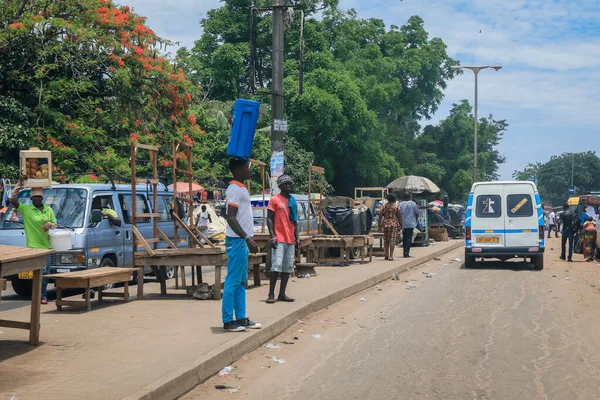 Kumasi, Ghana - April 06, 2022: Crowded African Road with Local Ghana People in Kumasi city
