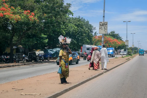 Kumasi, Ghana - April 06, 2022: Crowded African Road with Local Ghana People in Kumasi city
