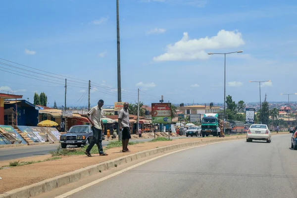 Kumasi, Ghana - April 06, 2022: Crowded African Road with Local Ghana People in Kumasi city