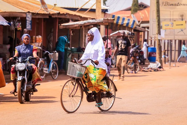 Tamale, Ghana - April 07, 2022: African Road with Local Ghana People on Vehicle in Tamale city