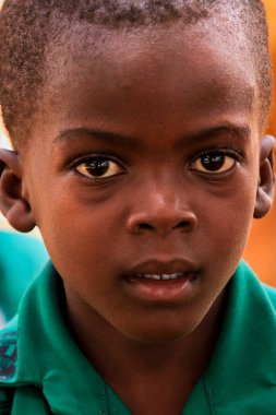 Amedzofe, Ghana - April 2022: African Pupils in Colorful School Uniform near the small Ghana Amedzofe town