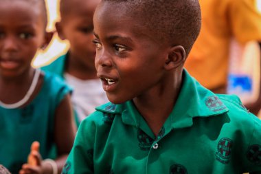 Amedzofe, Ghana - April 2022: African Pupils in Colorful School Uniform near the small Ghana Amedzofe town