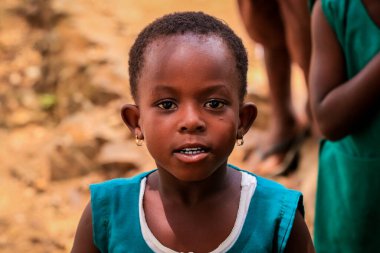 Amedzofe, Ghana - April 2022: African Pupils in Colorful School Uniform near the small Ghana Amedzofe town