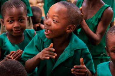 Amedzofe, Ghana - April 2022: African Pupils in Colorful School Uniform near the small Ghana Amedzofe town
