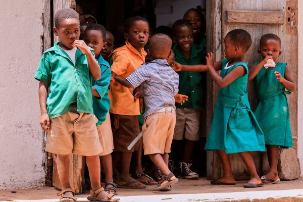 Amedzofe, Ghana - April 2022: African Pupils in Colorful School Uniform near the small Ghana Amedzofe town