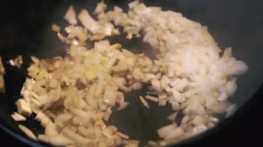 Vegetables are fried in a wok pan