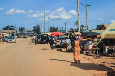 Cape Coast, Ghana - April 14, 2022: Cityscape of Local African Cape Coast town with Ghana People and Cars on the street