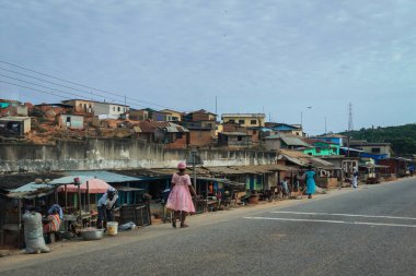 Cape Coast, Ghana - April 14, 2022: Cityscape of Local African Cape Coast town with Ghana People and Cars on the street