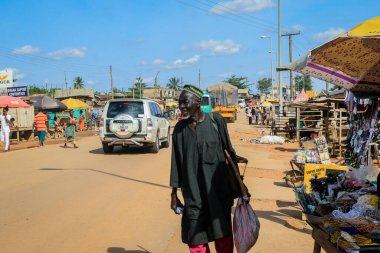 Cape Coast, Ghana - April 14, 2022: Cityscape of Local African Cape Coast town with Ghana People and Cars on the street