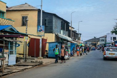 Cape Coast, Ghana - April 14, 2022: Cityscape of Local African Cape Coast town with Ghana People and Cars on the street