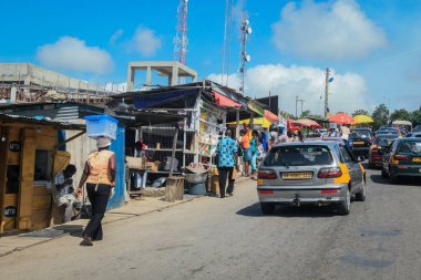 Cape Coast, Ghana - April 14, 2022: Cityscape of Local African Cape Coast town with Ghana People and Cars on the street