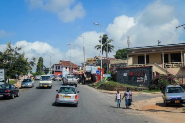 Cape Coast, Ghana - April 14, 2022: Cityscape of Local African Cape Coast town with Ghana People and Cars on the street