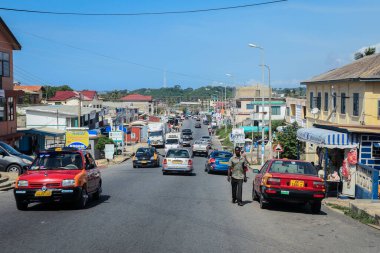Cape Coast, Ghana - April 14, 2022: Cityscape of Local African Cape Coast town with Ghana People and Cars on the street