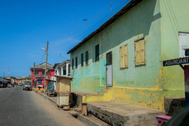 Cape Coast, Ghana - April 14, 2022: Cityscape of Local African Cape Coast town with Ghana People and Cars on the street