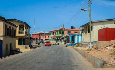 Cape Coast, Ghana - April 14, 2022: Cityscape of Local African Cape Coast town with Ghana People and Cars on the street