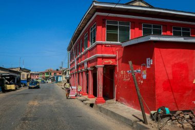 Cape Coast, Ghana - April 14, 2022: Cityscape of Local African Cape Coast town with Ghana People and Cars on the street