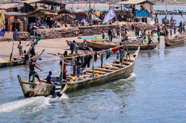 Elmina, Ghana - April 15, 2022: Atlantic Ocean View in the Elmina port with Boats and Local Fishermen in Ghana