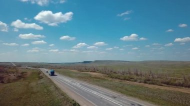 Highway In The Steppe With Passing Trucks, Aerial View