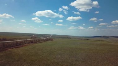 Highway In The Steppe With Passing Trucks, Aerial View