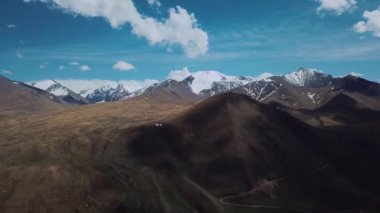 Highlands With Clouds And Snow-Capped Peaks, Aerial View