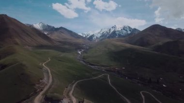 Highlands With Clouds And Snow-Capped Peaks, Aerial View