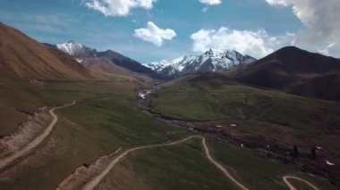 Highlands With Clouds And Snow-Capped Peaks, Aerial View