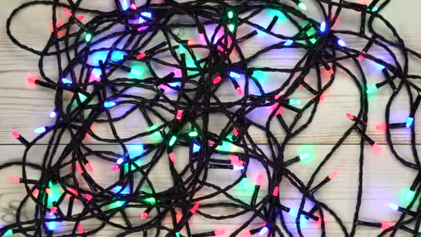 Christmas colorful lights on white wooden table — Stock Video