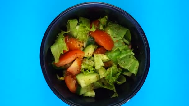 Tigela de salada gira sobre fundo vermelho. Salada com legumes frescos. Conceito de alimentação saudável — Vídeo de Stock