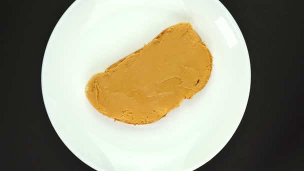Rotation of a peanut butter sandwich isolated on black. 360 degree rotation. — Vídeo de Stock