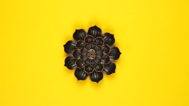 Design concept. Flower, metal candlestick rotating on yellow background. — Video Stock