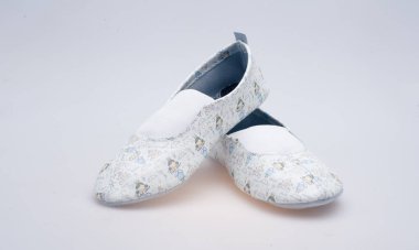 Beyaz arka planda yakın plan desenli deri ayakkabılar.