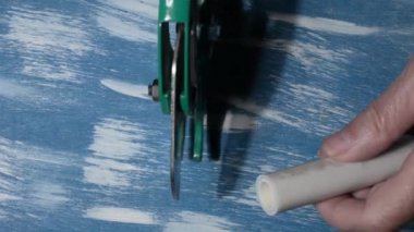 Tesisatçı lehimlemeden önce metal-plastik boruları keser. Kapat.