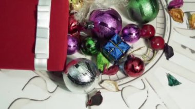 Pembe ve yeşil Noel süslemeleri olan parlak parlak süslemeli bir kutu. 360 derece dönüş. Üst Manzara. Tatil ve kutlama konsepti