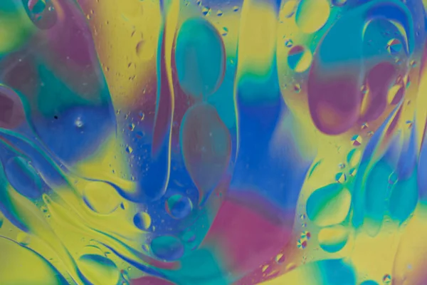 vegetable oil colored bubbles above water